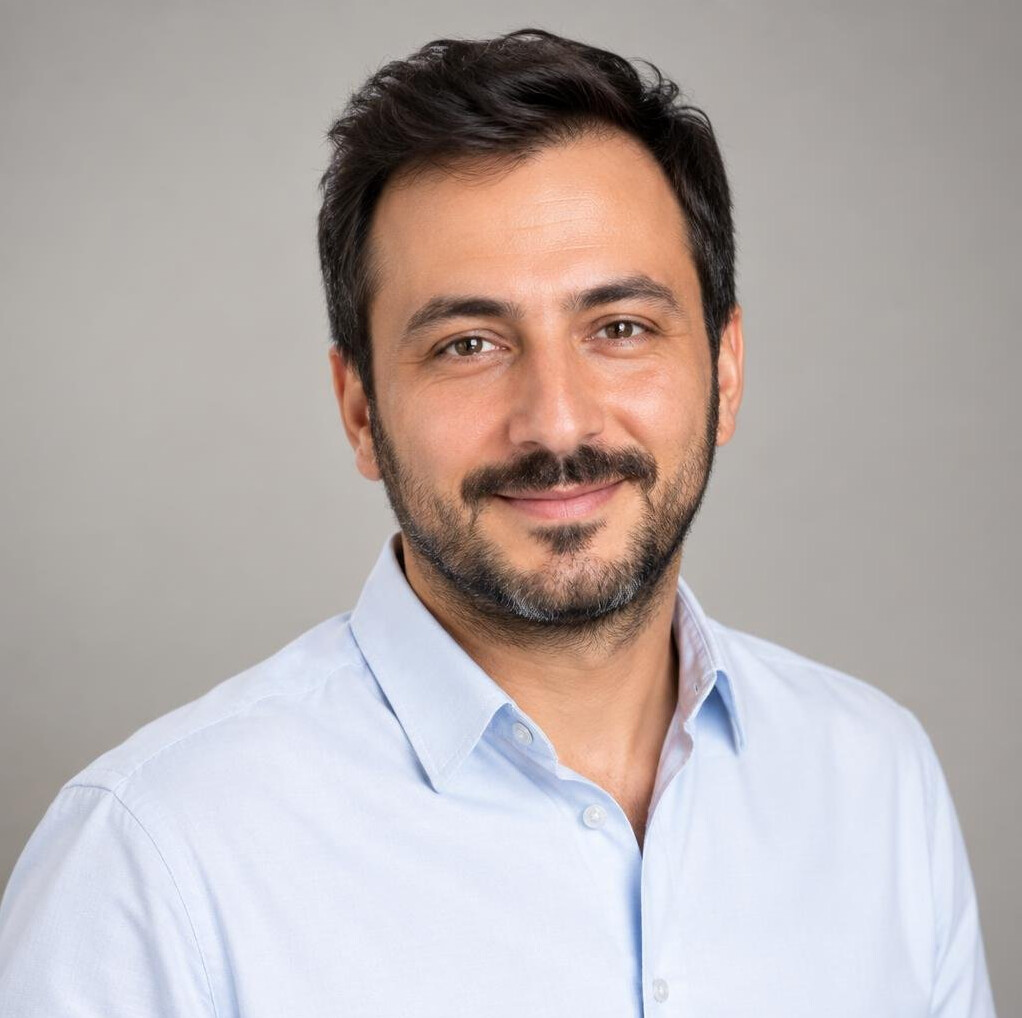 Portrait of a man with short hair in a plain shirt